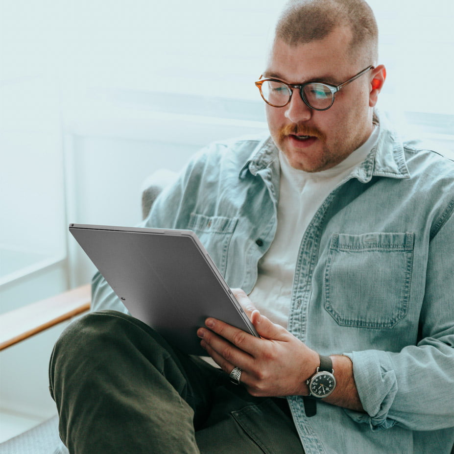 Man with tablet device, working on native advertising, always in control